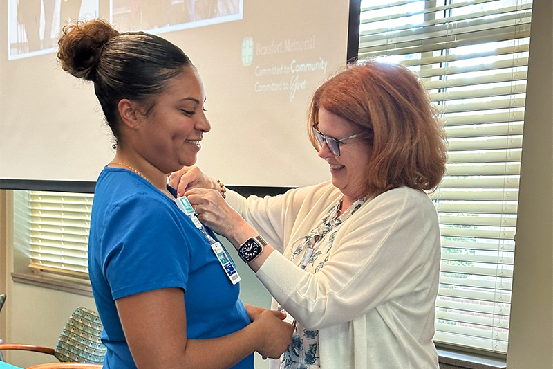 Alyssa Morgan, CCMA gets her certification pin from Mary Anne McNamee at the PATH graduation on August 20, 2025