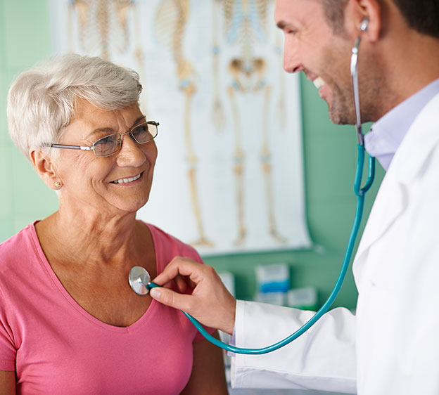 Physician checking the heartbeat of an older adult woman