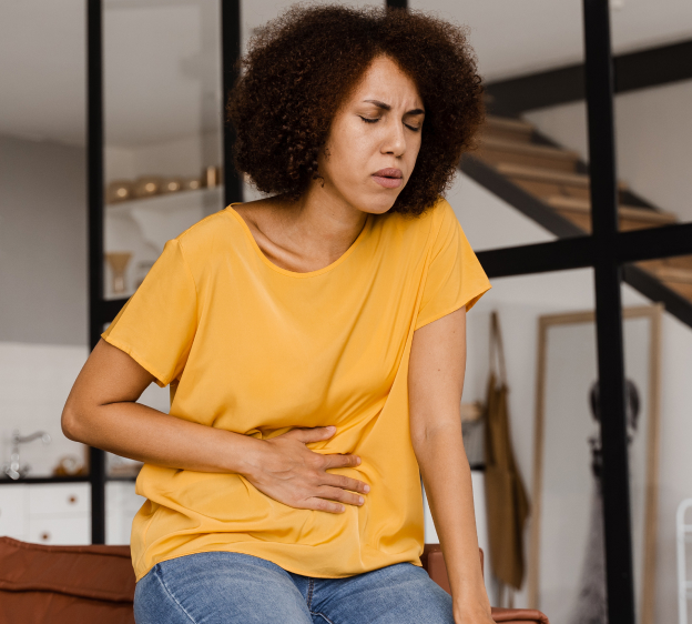 Adult women grimacing and holding her stomach