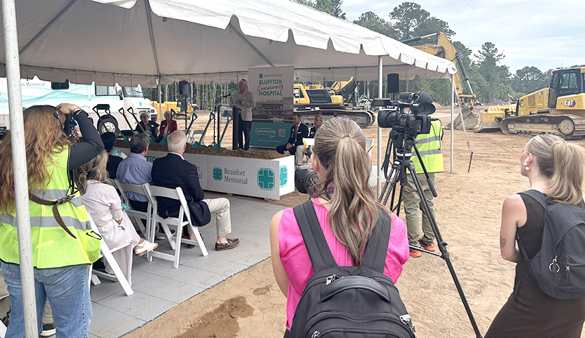 Reporters film footage at the groundbreaking