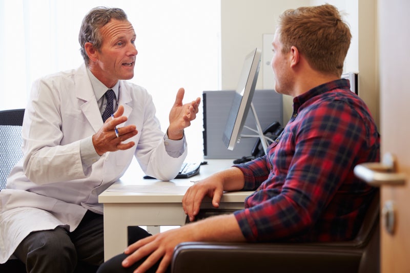 Patient having consultation with male doctor in a medical office
