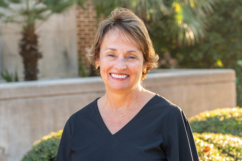 Karen Carroll smiles at the camera in an outdoor setting in Beaufort, South Carolina