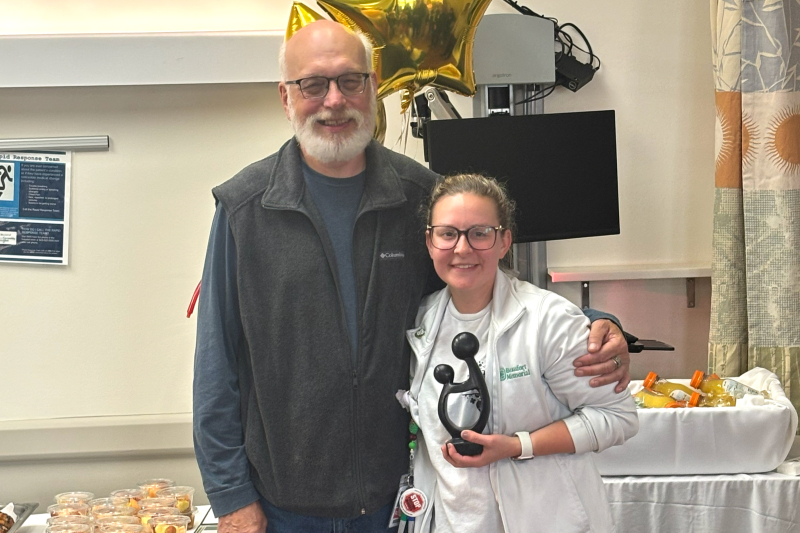 John Gearhart and Ashley Gearhart, holding her DAISY Award, after a small, surprise ceremony in November 2025.