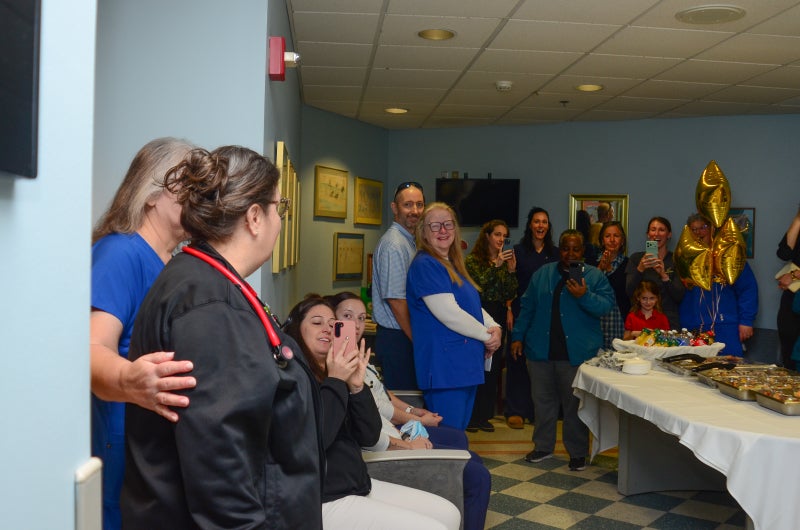 Candice Chappell walks into the Beaufort Memorial ICU break room for a surprise DAISY Award celebration