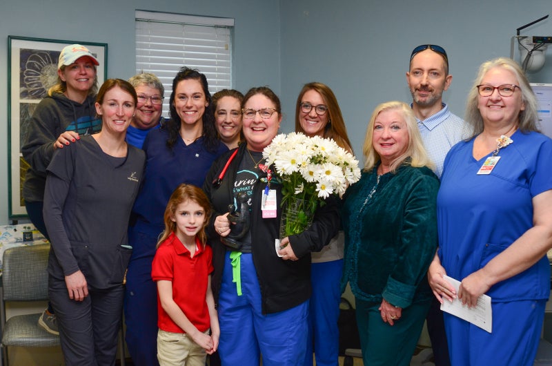 Candice Chappell poses for a photo with a group of family members and Beaufort Memorial colleagues