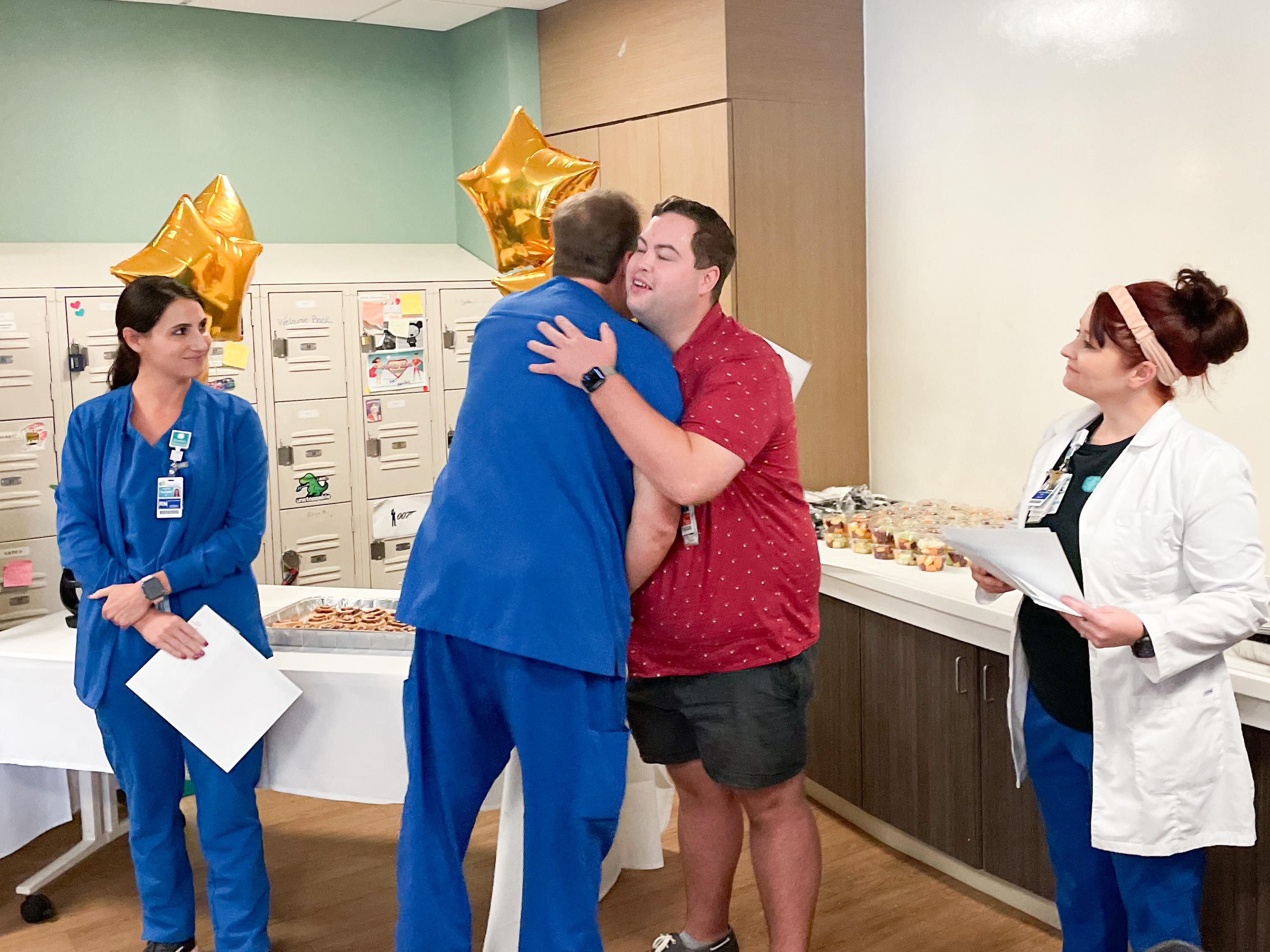 Jonathan Barrett, RN, BSN, hugs Kevin Kremer, Director of the Emergency Department at Beaufort Memorial Hospital