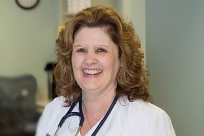 Lisa Terwilliger, RN smiles at the camera wearing a stethoscope around her neck