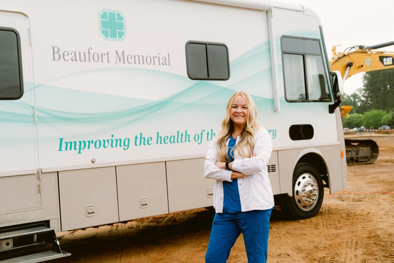 Tricia Evegan, Director of Nursing Supervisors and Float Pool at Beaufort Memorial, stands in front of the Mobile Wellness Unit