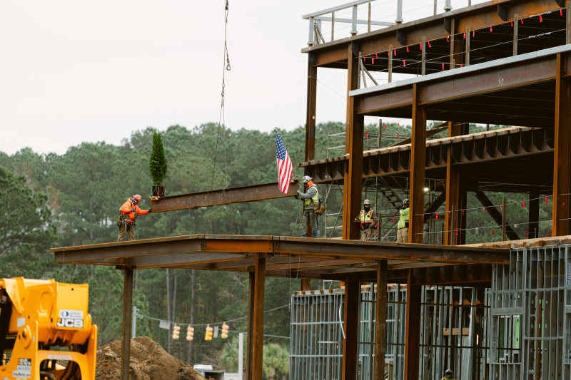 Construction workers place the final steel beam into place at the site of the Beaufort Memorial Bluffton Community Hospital, after current staff members, administration and other project partners signed it.