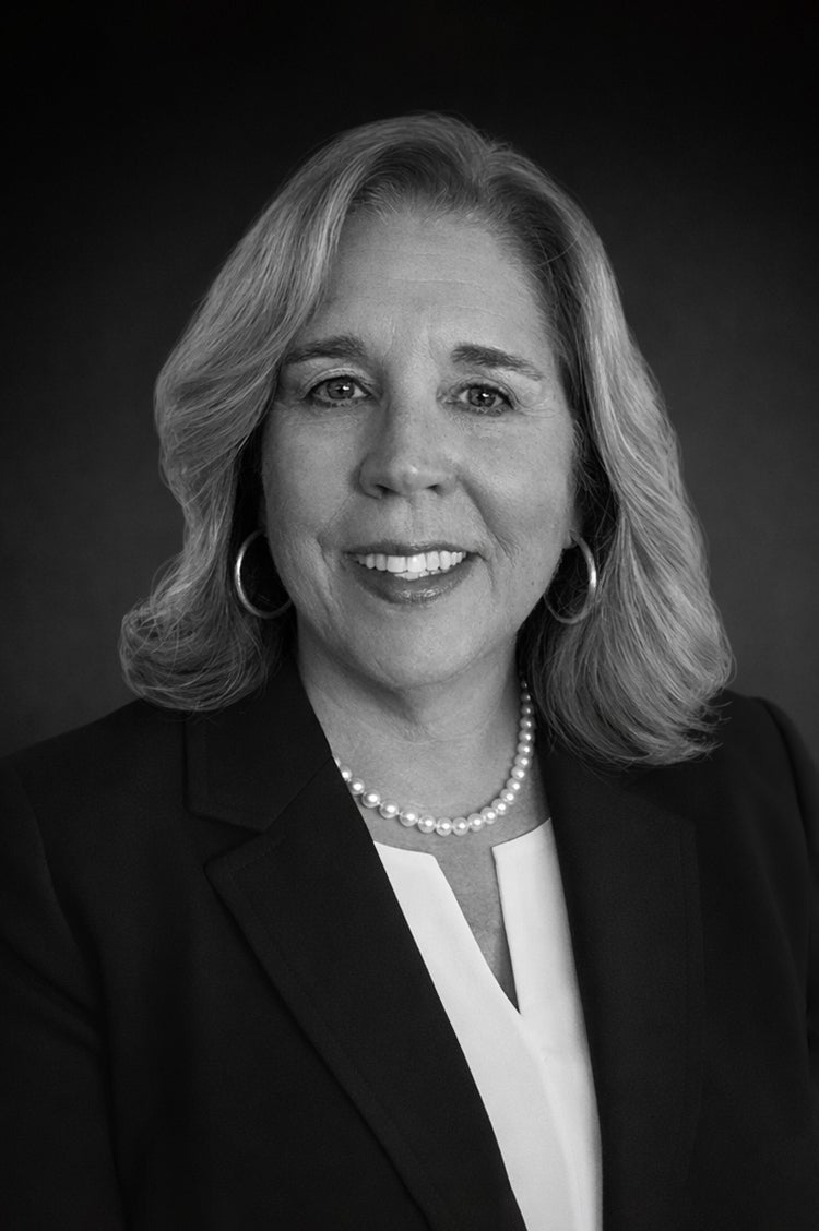 Professional black and white headshot of Janet Shelley
