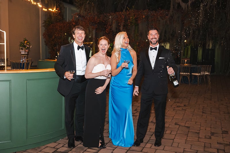 Chairs and co-chairs of the Beaufort Memorial Foundation's 2026 Valentine Ball pose for a photo wearing formal wear in an outdoor setting.
