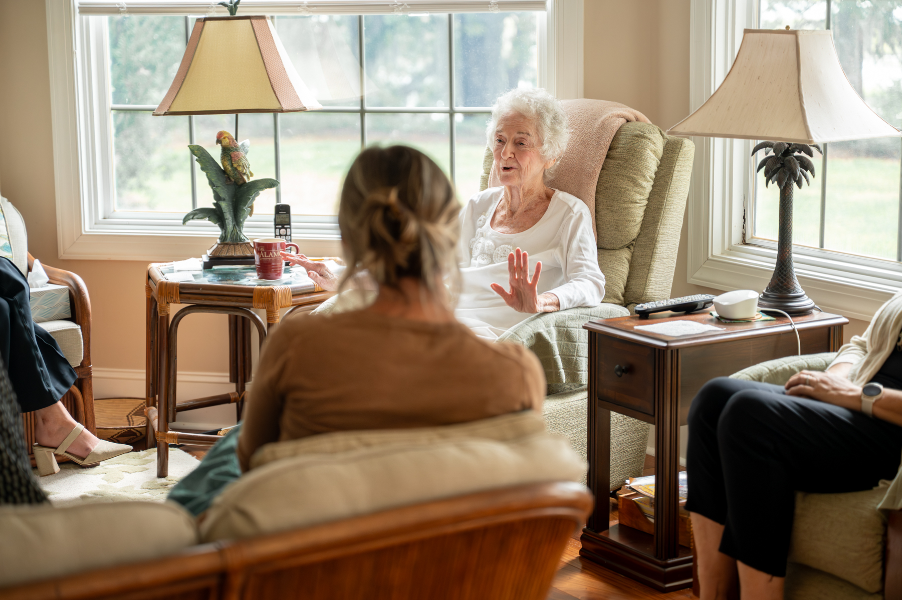 Mary McCarthy sits down in a living room to talk with Beaufort Memorial Foundation members
