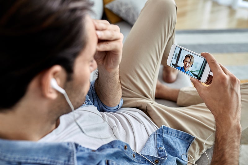 Male talks with a medical provider through a virtual video visit.