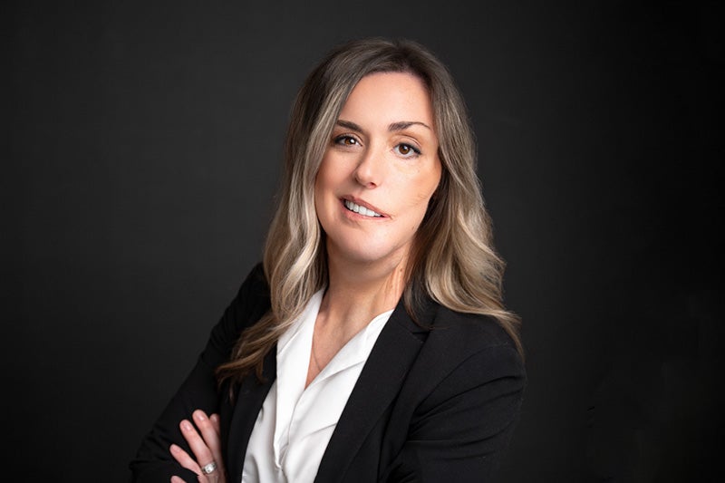 Professional photo of Kim Yawn, wearing a white blouse and a black suit jacket.