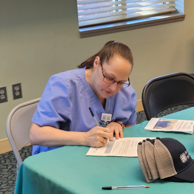 Krystal Reid signs a letter of intent for the Certified Medical Assistant pathway for cohort 12