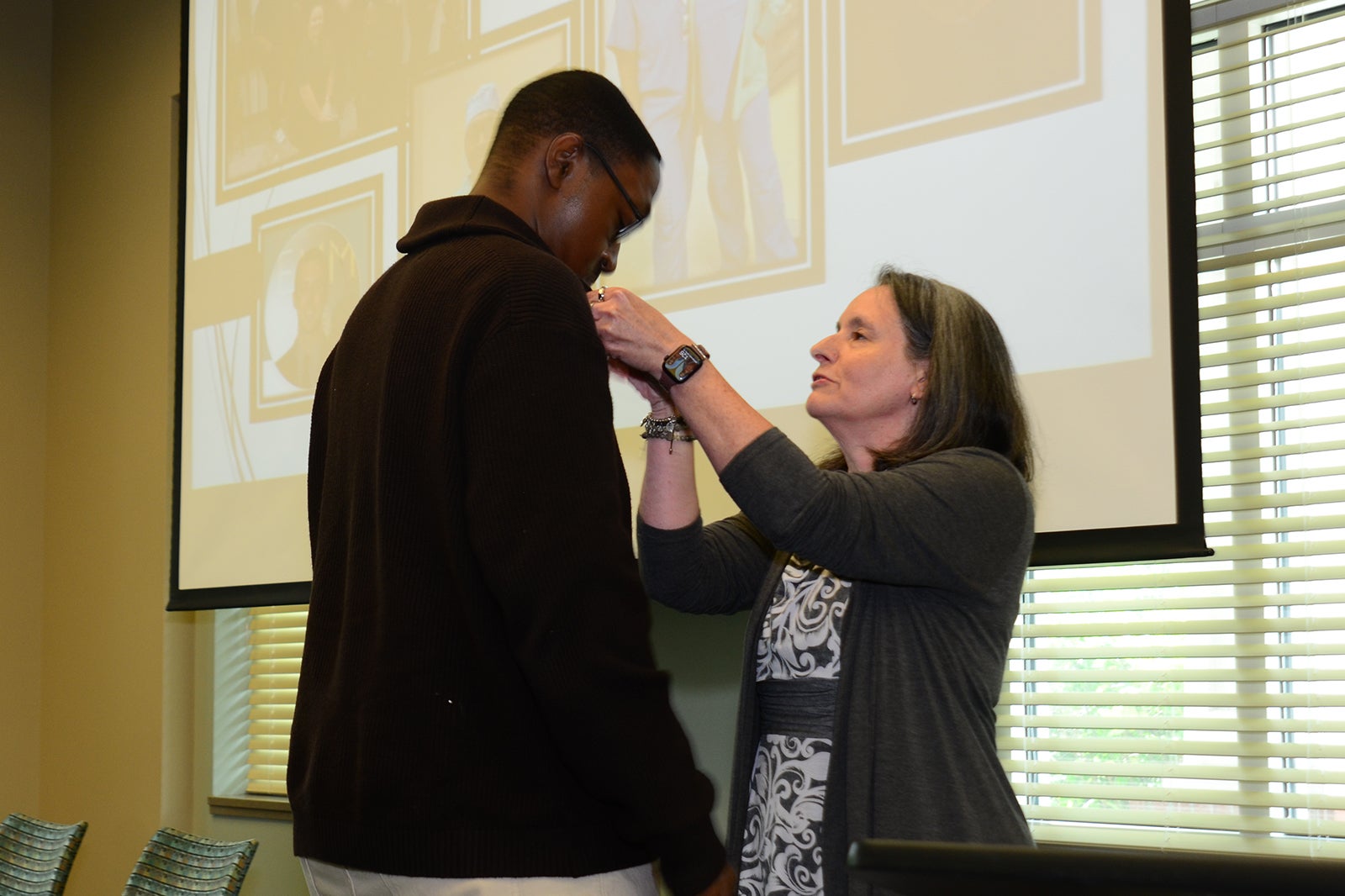 Devante Singleton, TS-C receives his national certification pin from Mary Beth Smearman, RN.
