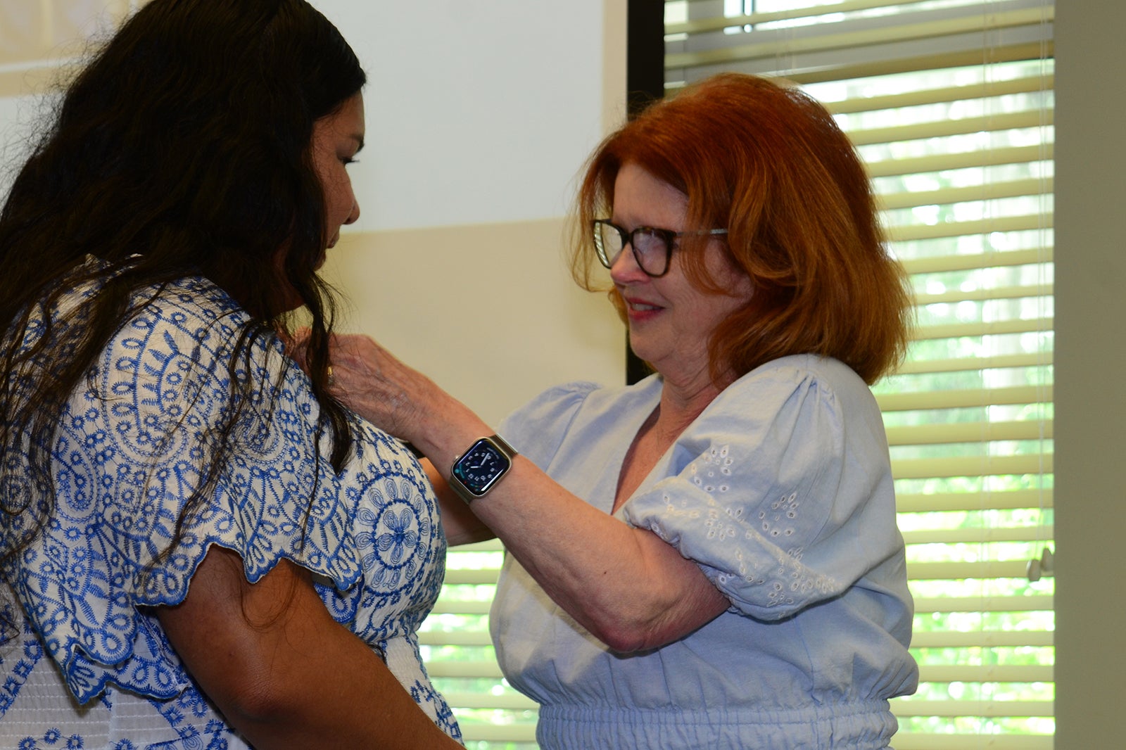Evelin Leija, CPCT receives her national certification pin from MaryAnn McNamara.