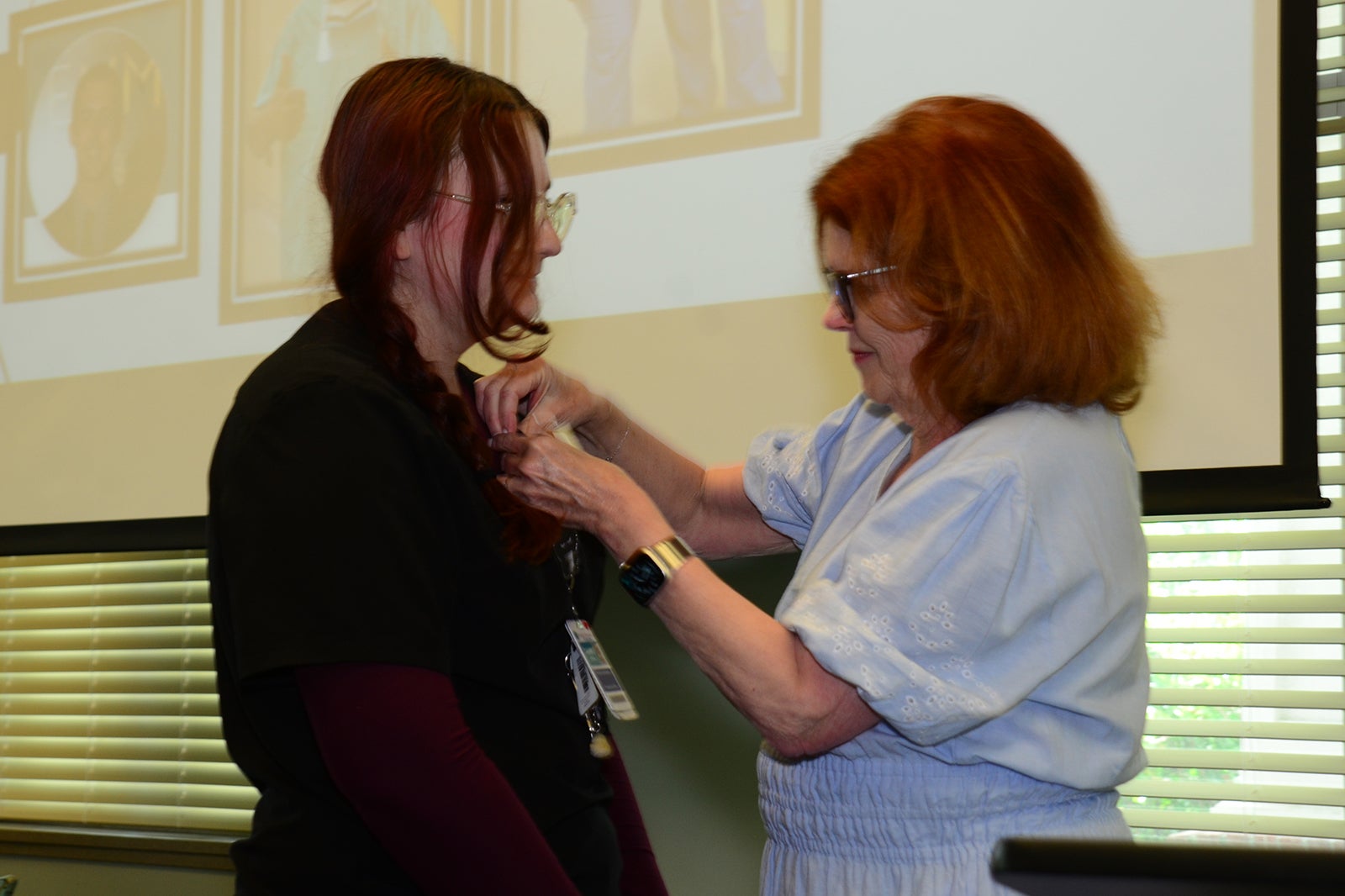 Kayla Jones, CCMA receives her national certification pin from MaryAnn McNamara.