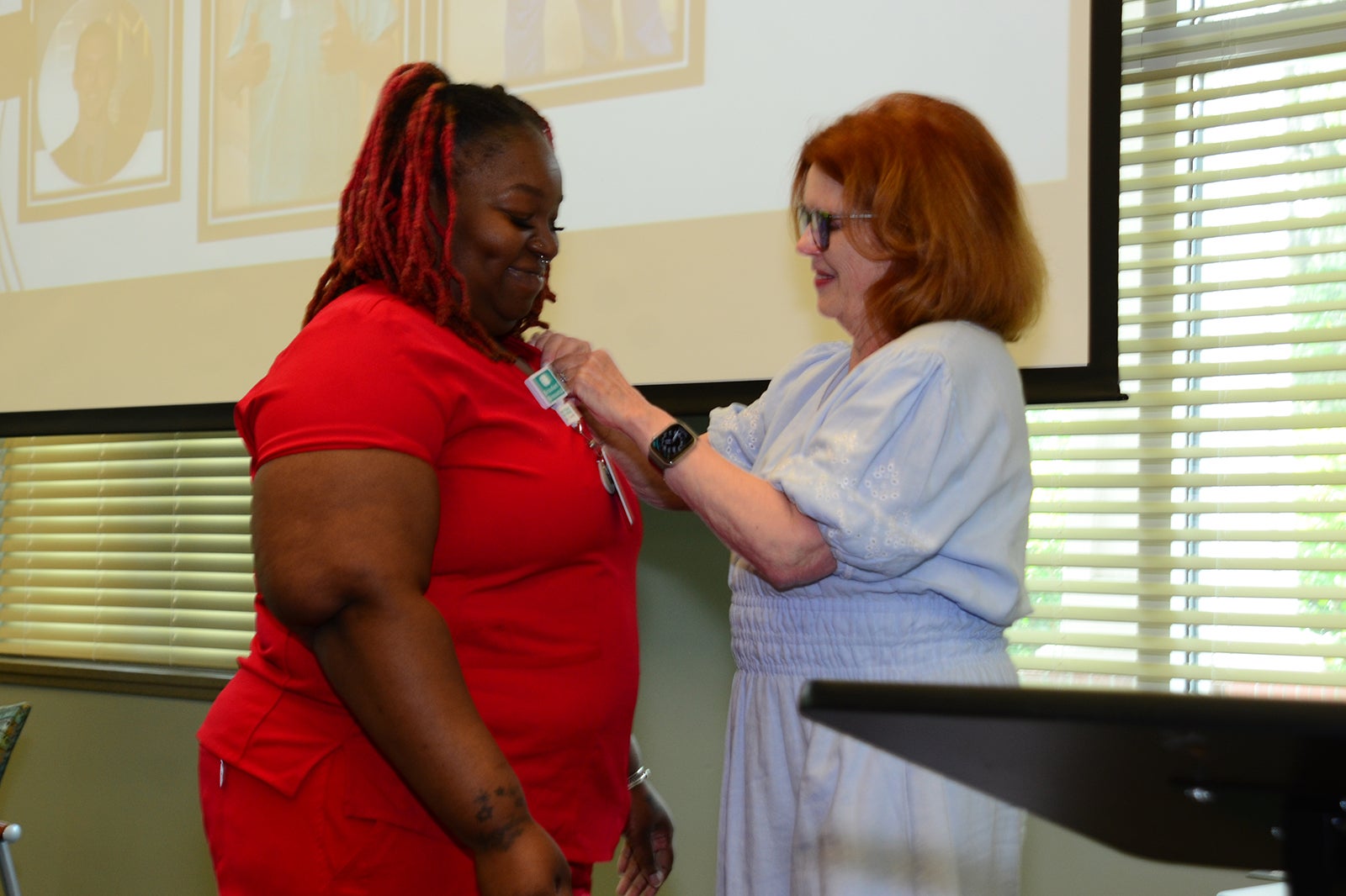 Tiffany Grober, CCMA receives her national certification pin from MaryAnn McNamara
