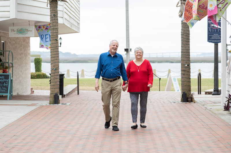 Marion Arbuckle and Glenda Arbuckle walk along a sidewalk in Downtown Beaufort