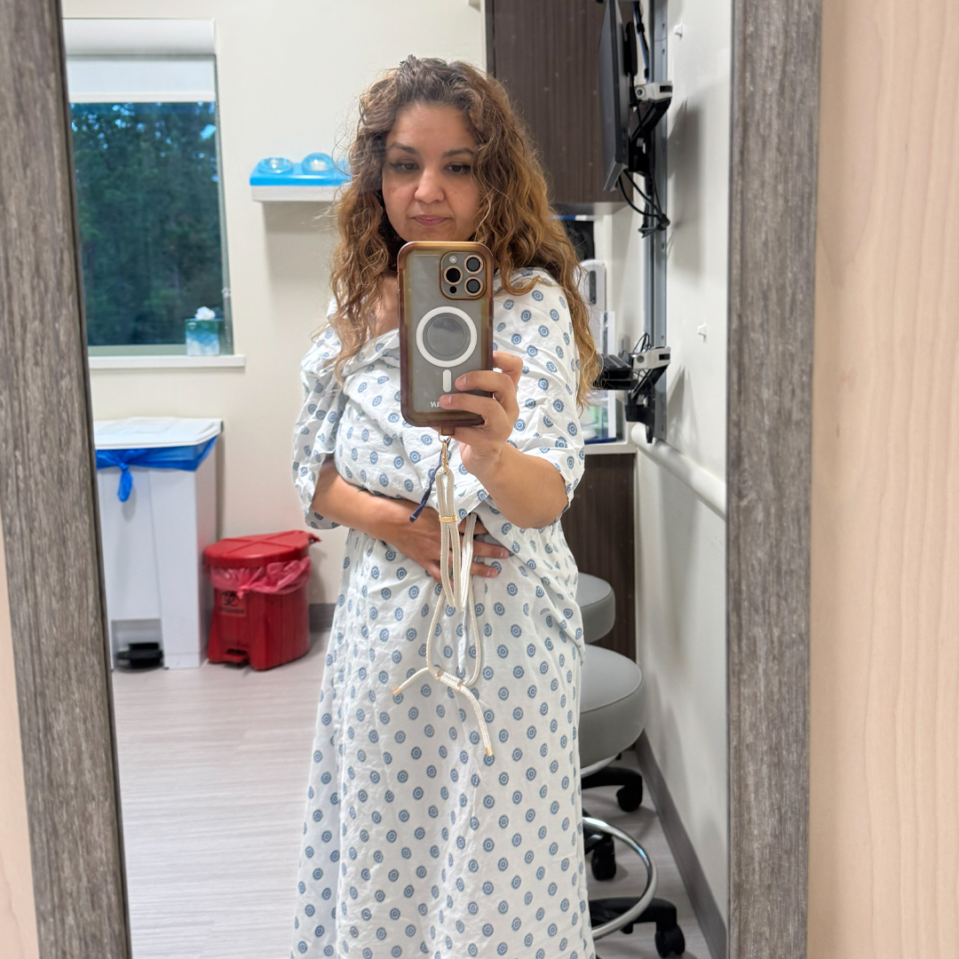 Grissela Bustamante poses in front of a mirror at Beaufort Memorial Plastic Surgery and Aesthetics