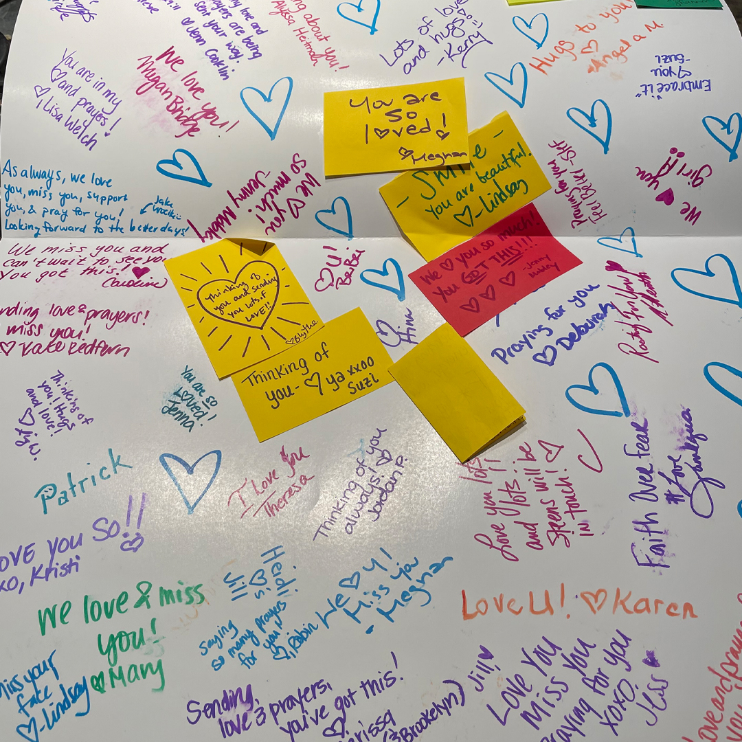 Supportive messages are written on an oversided card in support of Jill during her cancer treatment