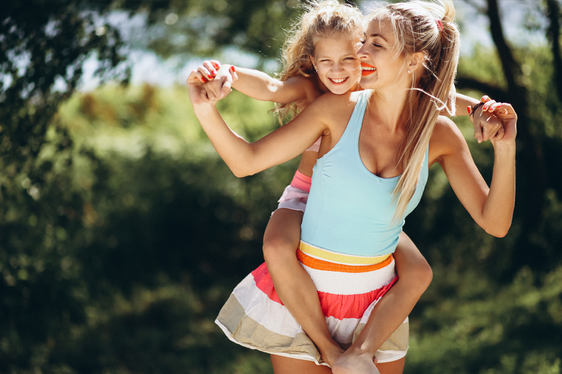 Young woman holding a child on her back