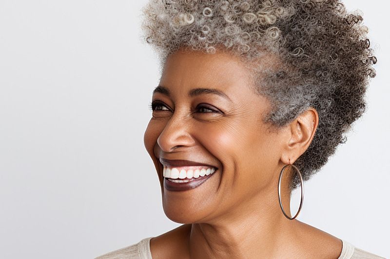 Aging African American woman looking to the side and smiling