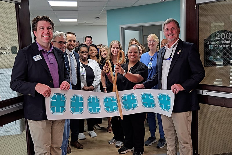 Beaufort Memorial employees stand amongst Town of Hilton Head Island, Chamber members and other guests at the ribbon cutting for 100 Exchange Street Suite 200.