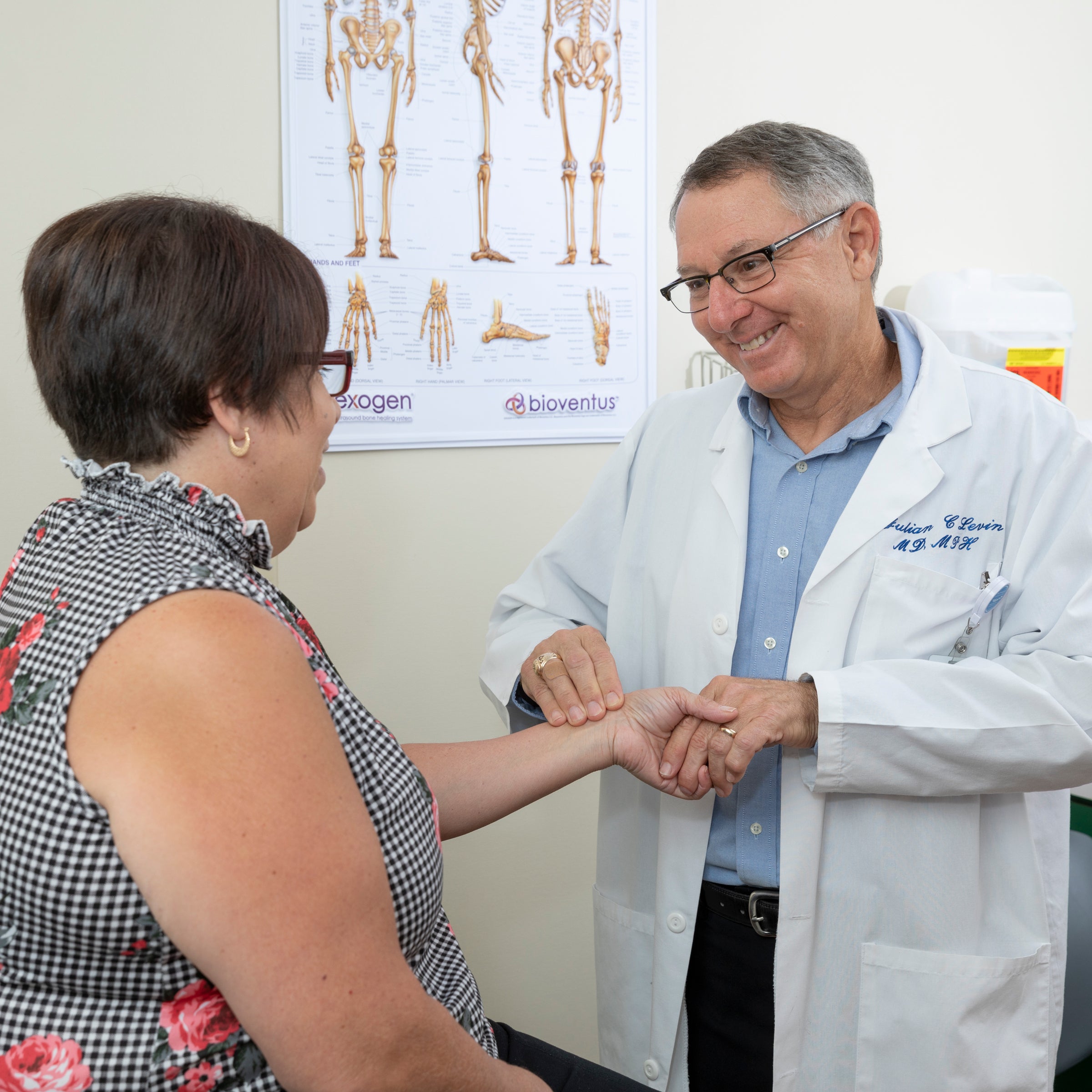 Quick Care at Beaufort Memorial belly band image of Dr. Levin and a female patient in a clinical room.