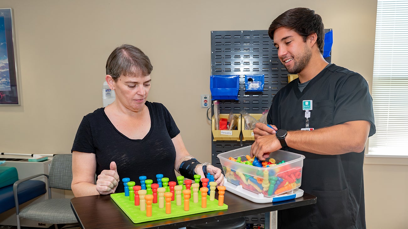outpatient rehabilitation patient works with a therapist for a wrist injury
