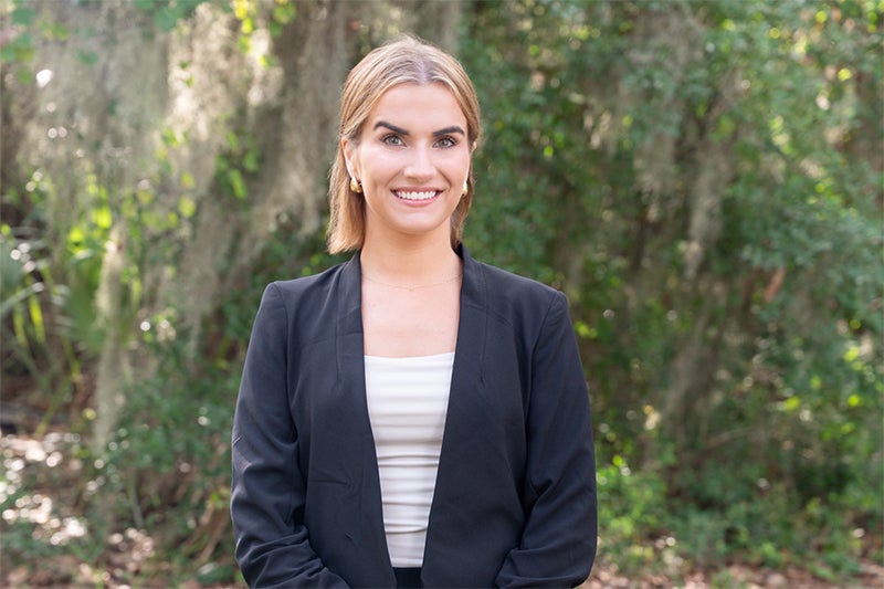 Dr. Meredith Hernandez, a urologist at Beaufort Memorial, stands in an outdoor Lowcountry setting.