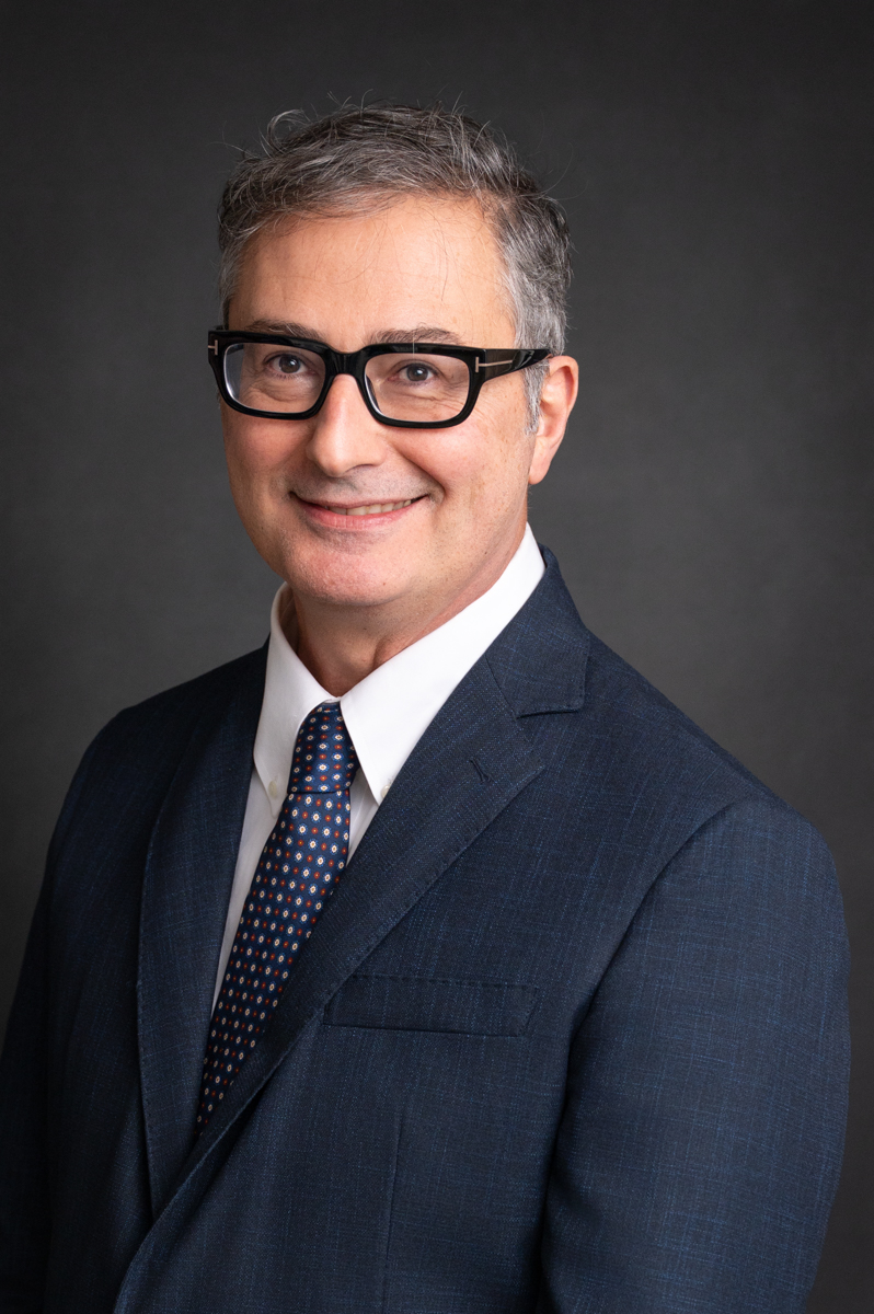 Professional photo of Dr. Maurizio Buscarini in a dark suit 