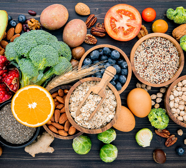 Table that contains cholesterol-lowering oats, nuts, broccoli, chickpeas, brussels sprouts, whole grains and blueberries