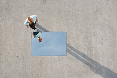 Woman looking at mirror on ground