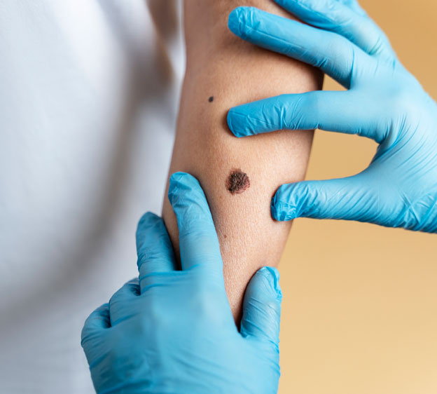 A male dermatologist examines a young woman’s face.