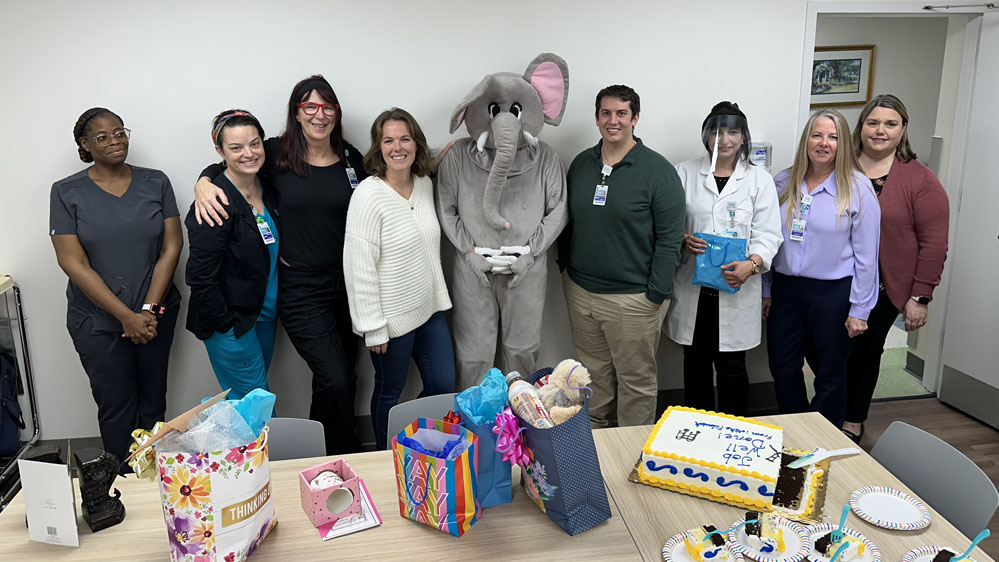 Banjo, an elephant macot, poses with BMH staff
