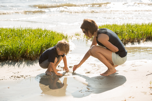 mother and child playing in water