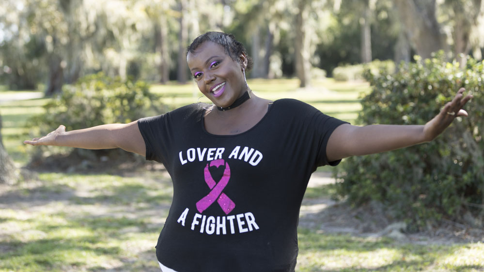 breast cancer survivor with open arms