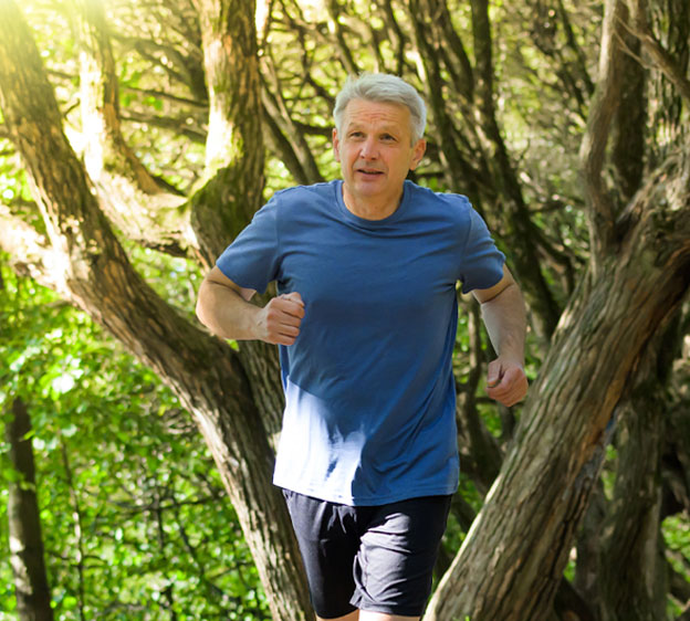 Middle-age man jogging in a park