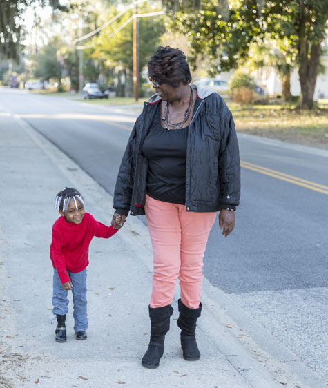 Sherline Holmes walking with her grand-daughter