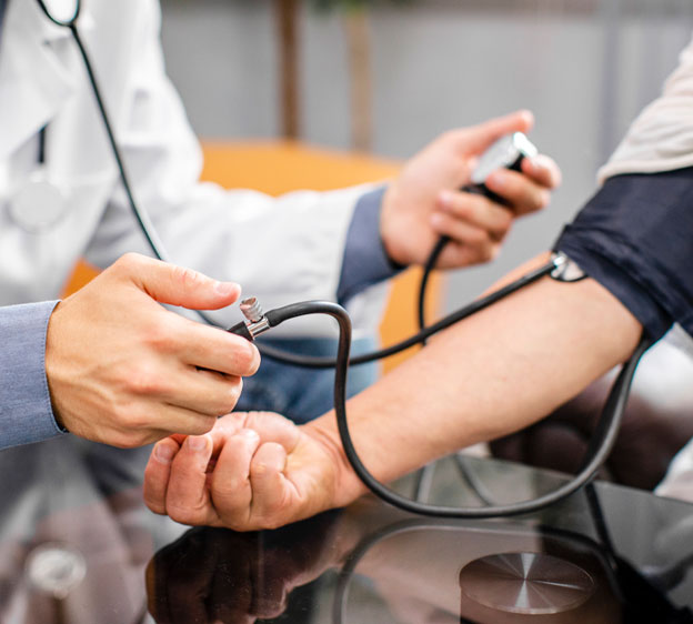 Doctor taking an adult's blood pressure