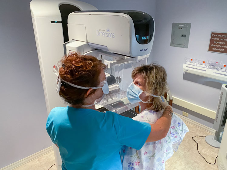 breast health employee with patient