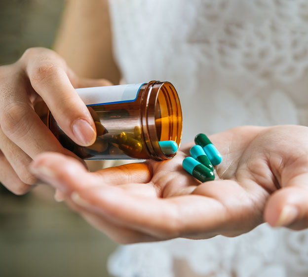 woman pouring antibiotics into her palm