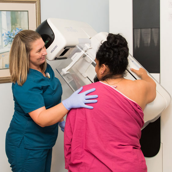 Tech performs a mammogram