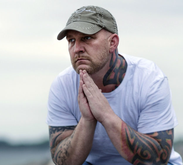 depressed man sitting at the shore