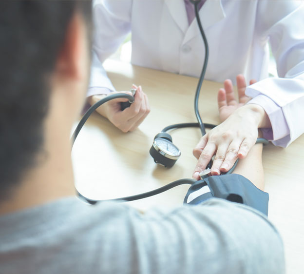 A health care provider takes a patient’s blood pressure.