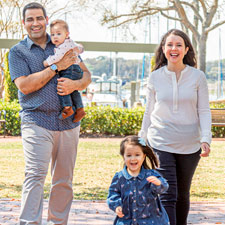 beaufort memorial orthopaedic surgeon dr vandit sardana smiles at camera with his wife Joanna and two children Sophia and Henry
