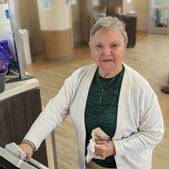 ED Ambassador Terry Wade cleans a kiosk at the hospital.