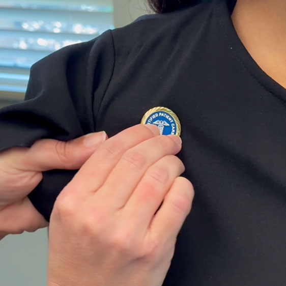 A pin is being placed on a shirt